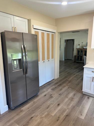 a kitchen with a stainless steel refrigerator in a room at Retreat on the Bayou in Port Richey