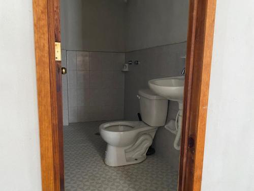 a bathroom with a toilet and a sink at Villa Sofia in Tlatlauquitepec