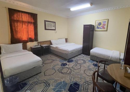 Ένα ή περισσότερα κρεβάτια σε δωμάτιο στο Saba Furnished Apartments