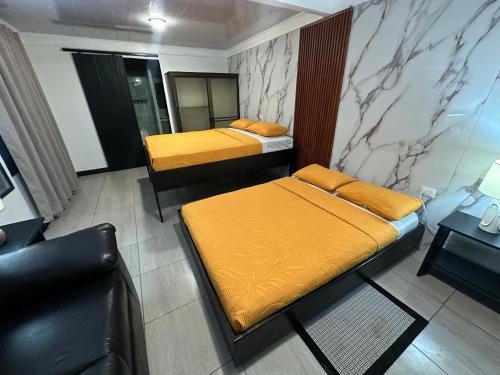 a room with two beds and a couch in it at Caribbean View in Tortuguero