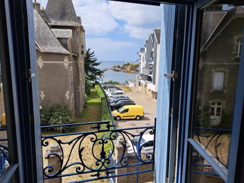 une vue depuis une fenêtre d'une rue avec une voiture jaune dans l'établissement Apartment in Le Pouldu near Atlantic Beaches, au Pouldu