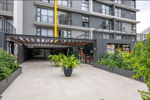 a building with a courtyard with potted plants at The Gateway Getaway in Durban
