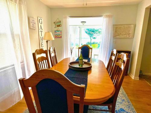 a dining room with a wooden table and chairs at Dog-Friendly Oceanfront Getaway - Walk to Dining - Private Beach Access in Milford