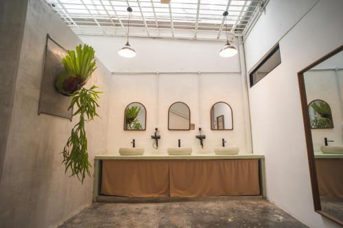 a bathroom with three sinks in a room at Carnarvon 73 in George Town
