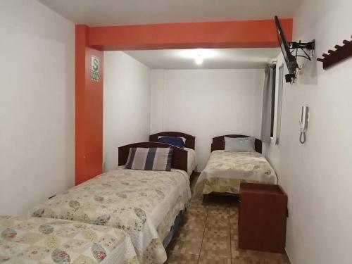 a room with two beds in a room at Gran Hotel Leguia in Cajamarca