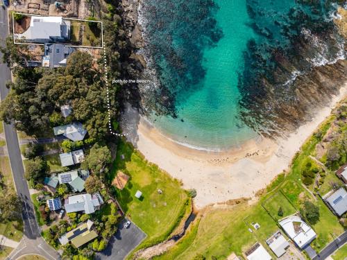 an aerial view of a beach with houses and the ocean at Garden Bay Coastal Retreat in Malua Bay
