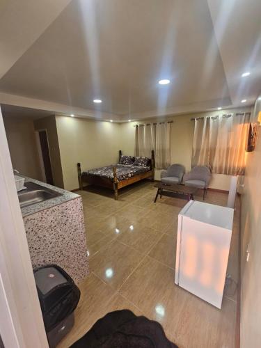 a living room with a bed and a couch at Lion's Guest House in Warner in Mahaut