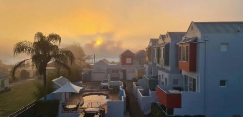 a row of houses with a rainbow in the background at 9 By the Clyde, Central Location in Batemans Bay in Batemans Bay