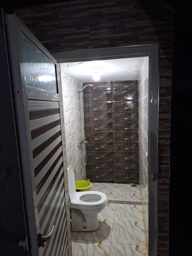 a bathroom with a toilet in a room at La Pause Dar Bouazza in Tamaris