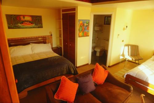 a bedroom with a bed and a couch in it at Hotel Puerto Mayor in San Antonio