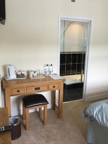 a wooden desk in a bedroom with a mirror at Bryn Derwen in Rhayader