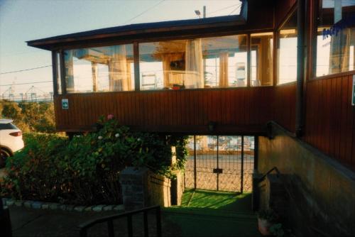 a house with a balcony on the side of it at Hotel Puerto Mayor in San Antonio