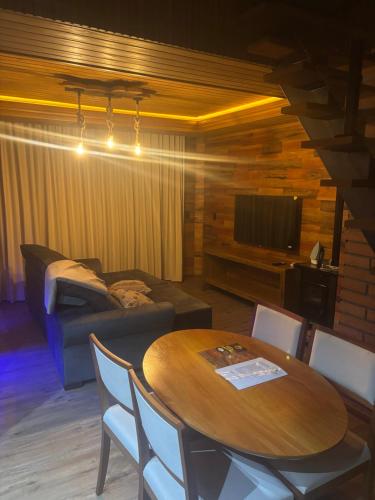 a living room with a table and a couch at Paraíso da Harmonia in Teutônia