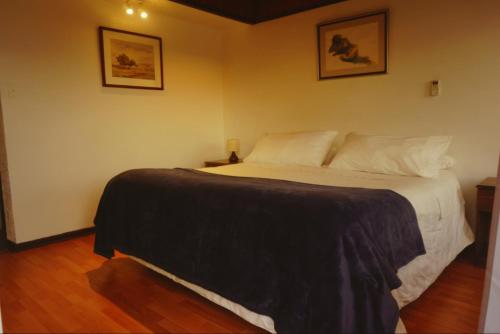 a bedroom with a large bed in a room at Hotel Puerto Mayor in San Antonio
