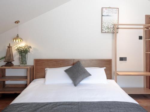 a bedroom with a white bed with white pillows at Dan's House - Near Lingyin Temple in Hangzhou