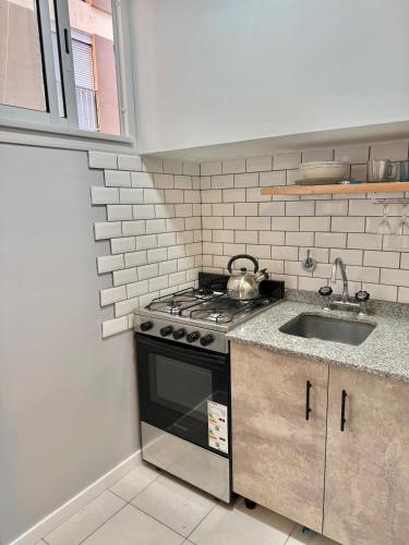 a kitchen with a stove and a sink at Blue Ocean in Mar del Plata