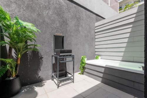 a bathroom with a bath tub and a tv on a table at Fliphaus ChicHaus 9 Lux Units 36 pax Daily Housekeeping! in Buenos Aires