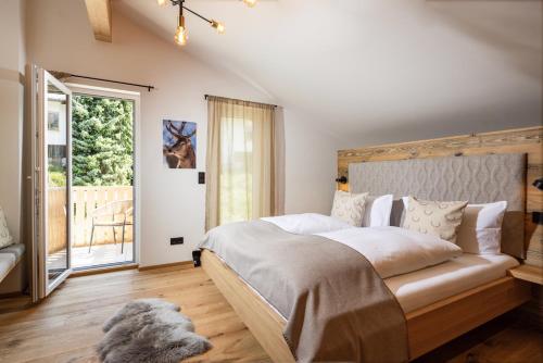 a bedroom with a bed with a dog laying on the floor at Das Gipfelglück in Berchtesgaden