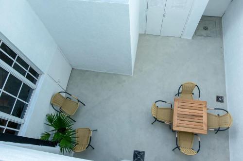 a room with chairs and a table and a plant at Fliphaus Nicaragua 5800 - Duplex with Patio in Palermo Hollywood in Buenos Aires