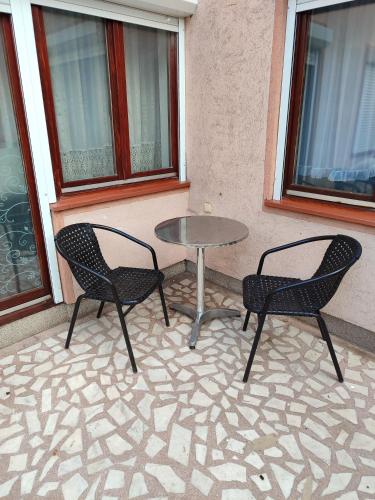 two chairs and a table on a patio at Apartman Stay 23 in Smederevo