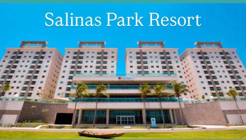 a large building with palm trees in front of it at Salinas GAV Resorts in Salinópolis
