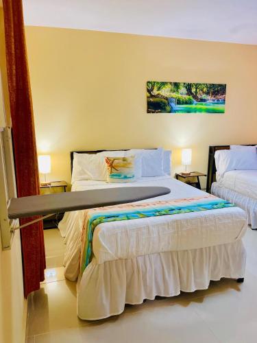 a bedroom with two beds in a room at Clora Hotel 