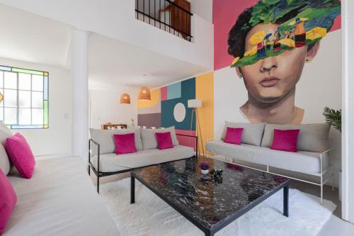 a living room with a large painting of a man at Fliphaus Villa Soho Vibes - Lux House Palermo Soho in Buenos Aires