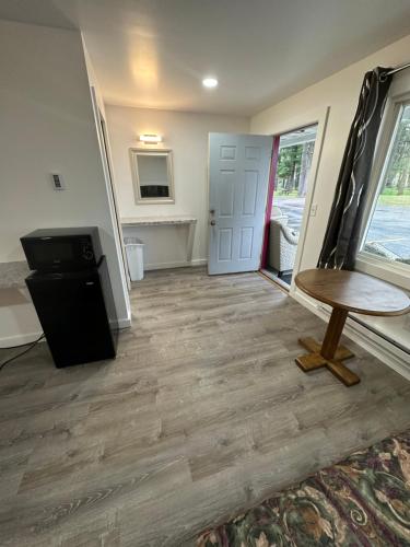a living room with a table and a door at Lake Aire Motel in Wisconsin Dells