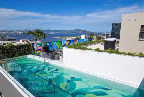 a swimming pool on the roof of a building at NOVO Skylux 1109 Imponente com Piscina Aquecida WIFI in Rio de Janeiro