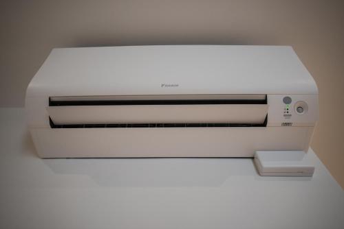 a white printer sitting on top of a wall at F53 Kevin's Charming Houses in Alghero