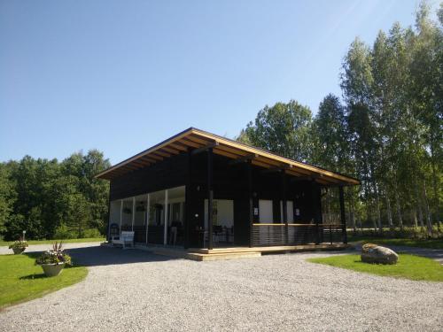 a large white building with a large window at Savonlinna Camping Vuohimäki in Savonlinna