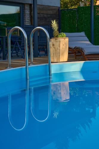 a swimming pool with blue water in a house at Shi-lu 