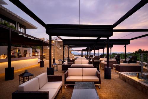 a bar with couches and tables on a building at Hilltop Resort Fukuoka in Fukuoka