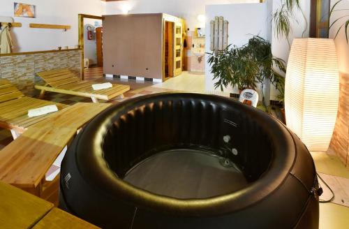 a large black chair in a room with a table at Hotel Kovarna in Děčín