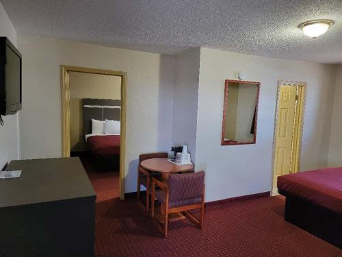 a hotel room with a table and a bed at Americas Best Value Inn-Williams/Grand Canyon in Williams