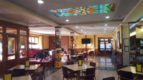 a restaurant with tables and chairs and a stained glass ceiling at Hotel del Sol in Motilla del Palancar