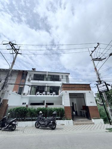 two motorcycles parked in front of a building at Ging's Beach & Pool in Hua Hin