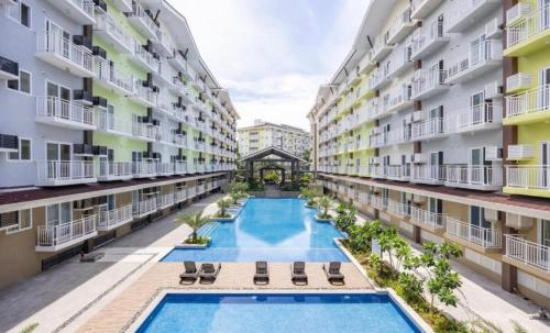 an image of an apartment complex with two pools at Condo unit near Mactan Airport with Pool, Gym, Free WiFi, and Netflix in Pusok