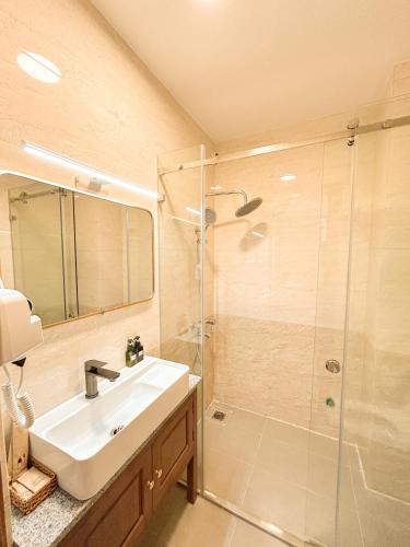 a bathroom with a sink and a shower at Gió Hotel in Huế in Hue