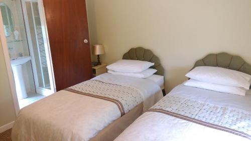 two beds sitting next to each other in a room at Gortnaboul House in Kilgarvan