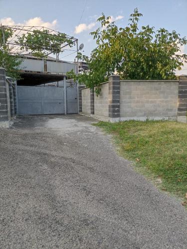 a driveway with a garage and a building at Scenic Home Near Naguti in Chiatʼura