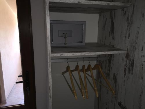 a room with a shelf with wooden utensils on it at Family Hotel Malibu in Chernomorets