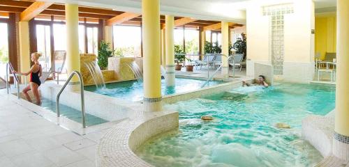 a woman is standing in a swimming pool at Villa Valentina Spa in Umbertide