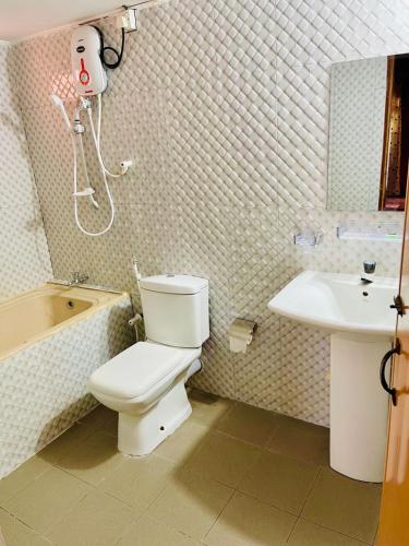 a bathroom with a toilet and a sink at Anandas Beach Resort in Trincomalee