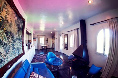 a living room with blue chairs and a table at Pikes Ibiza in San Antonio