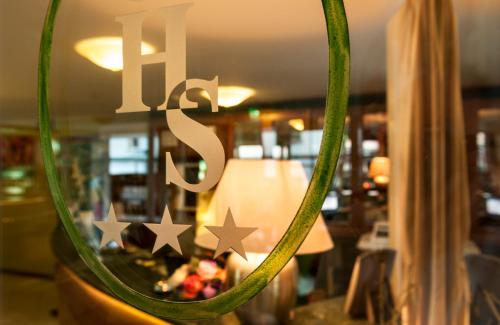 a close up of a mirror with some green rope at Hotel Sandra in Rimini
