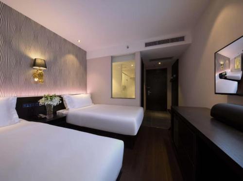 a hotel room with two beds and a desk at Orange Hotel Beijing Shangdi Huandao in Beijing