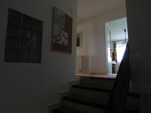 a hallway with stairs and a window in a house at Apartment Nad Punkvou in Těchov