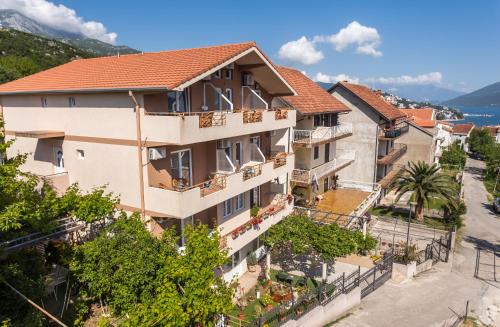 an image of a building in a town with trees at Durakovic Apartments in Herceg-Novi