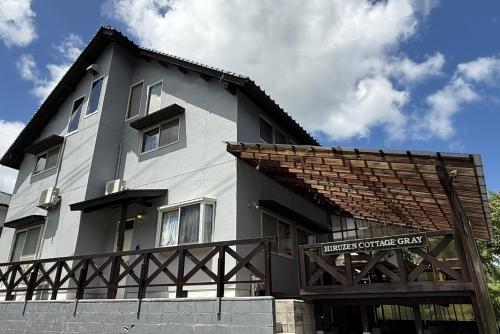 a white building with a sign in front of it at Okayama Hiruzen Villas Peter Pan in Makago